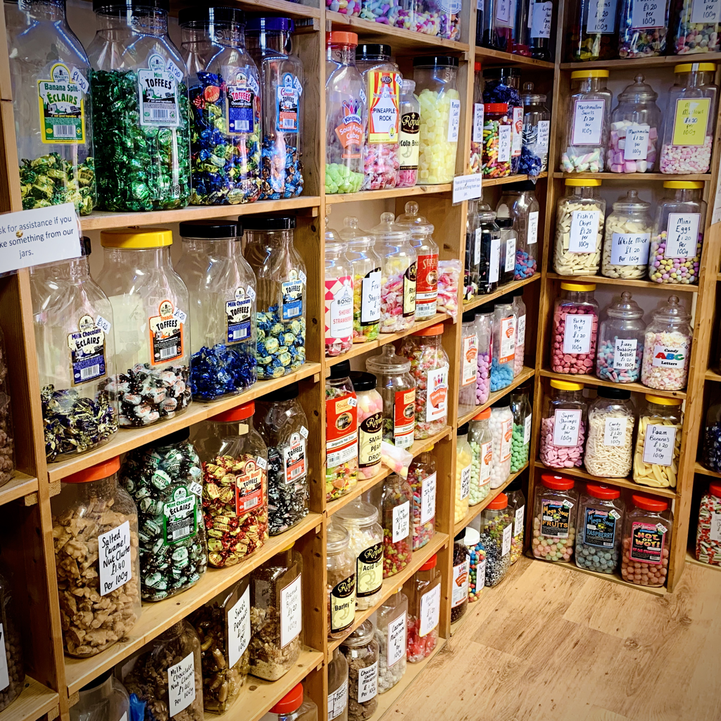 100g / a quarter of sweets from jars traditional weigh out sweets from glass / plastic jars retro old fashioned candy sweets fudge sweet shop in Coleshill north Warwickshire Birmingham 